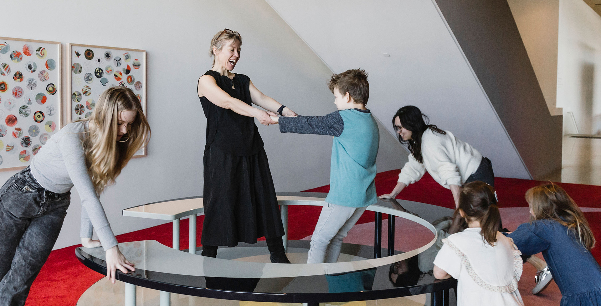 A group of people play on a carousel
