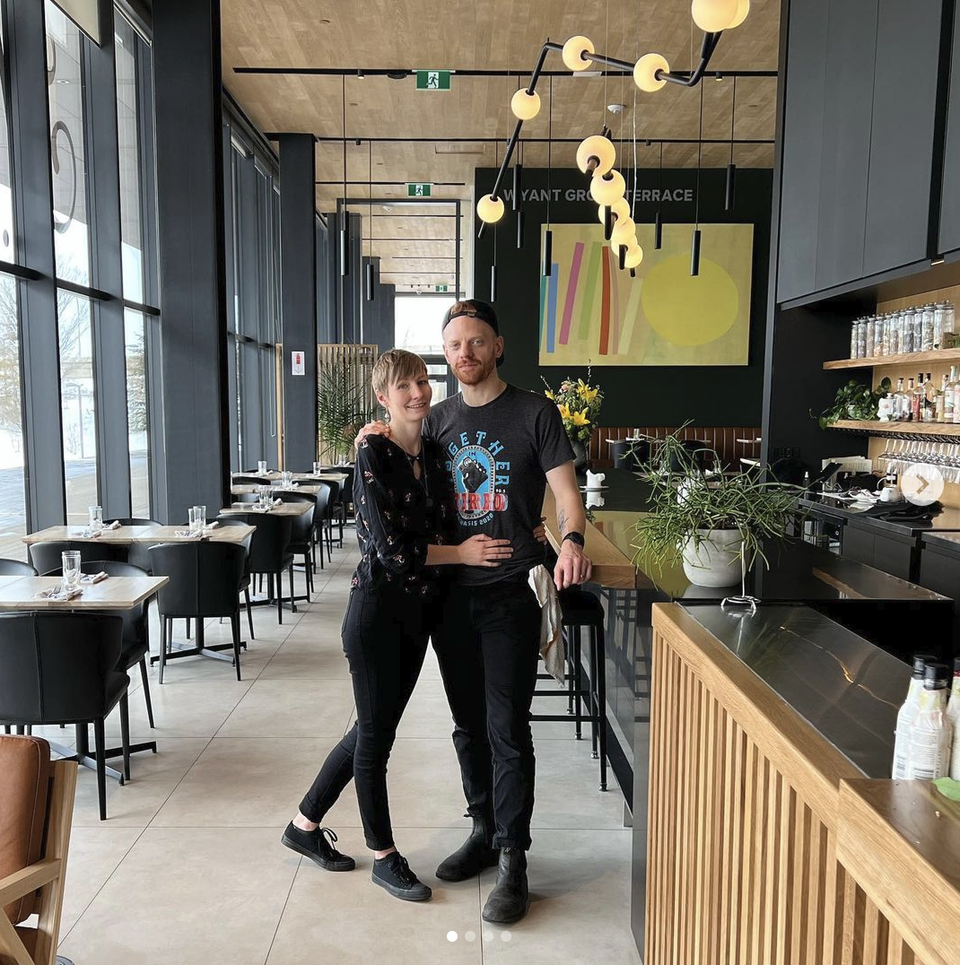 Beth and Thayne of Hearth Restaurant stand on the restaurant floor
