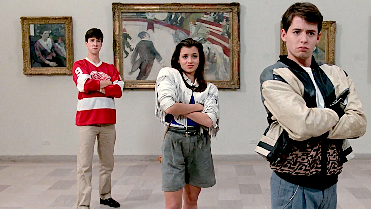 Three teenagers stand in a row inside an art museum, each with arms crossed. On the right, a boy wears a beige and black leather jacket and poses confidently. In the centre, a girl in a white fringed jacket and high-waisted shorts smiles slightly. On the left, another boy wears a red Detroit Red Wings hockey jersey and looks uncertain. Behind them are several framed paintings on the wall, including Georges Seurat’s A Sunday Afternoon on the Island of La Grande Jatte.