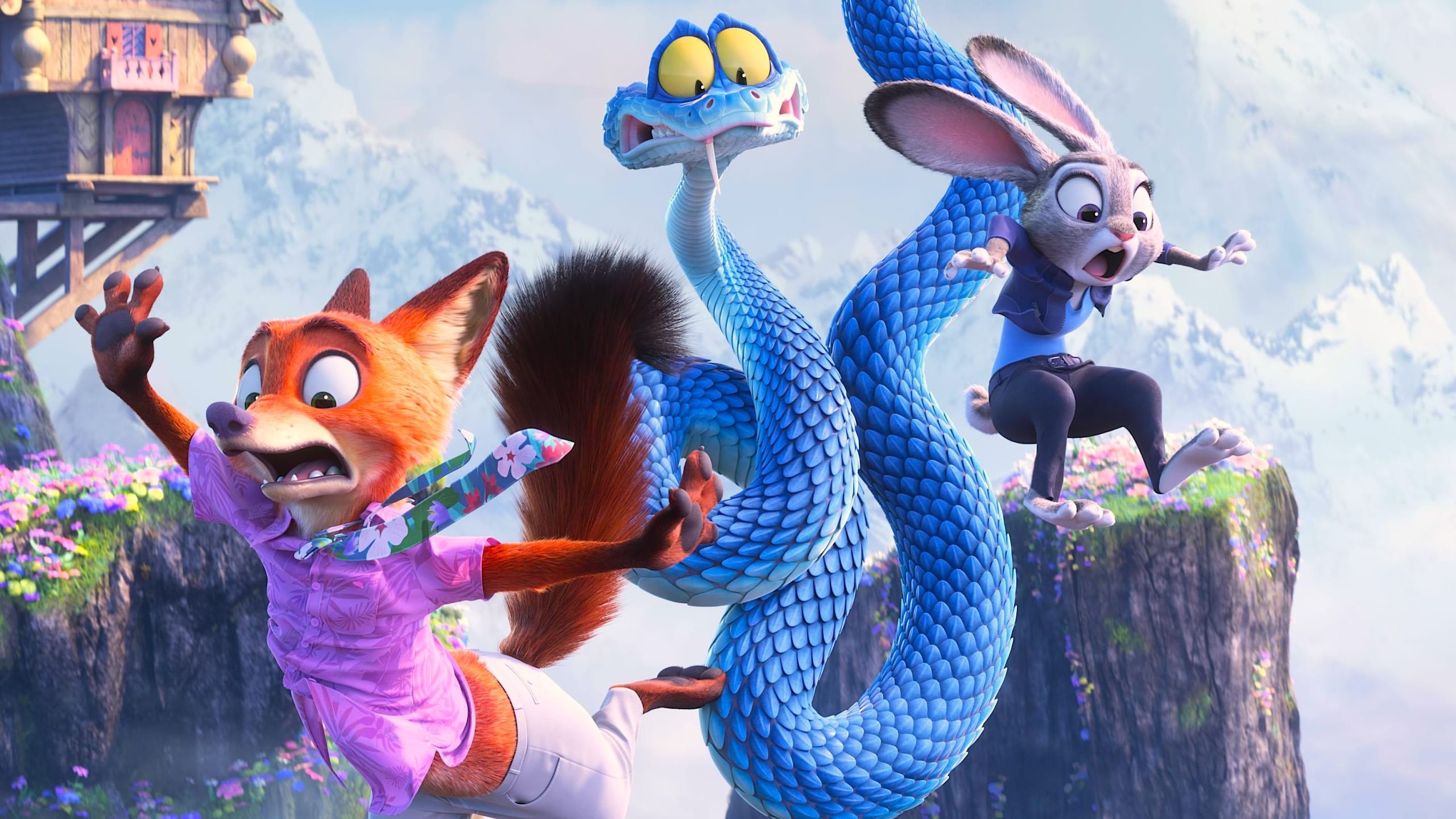 Three animated characters are midair in a chaotic moment on a mountain cliff. An orange fox in a pink shirt flails with a startled expression, a long blue snake twists between them with wide eyes and tongue out, and a gray rabbit in a blue outfit jumps backward in alarm. Behind them are steep cliffs, flowers, and a wooden structure perched on the edge.