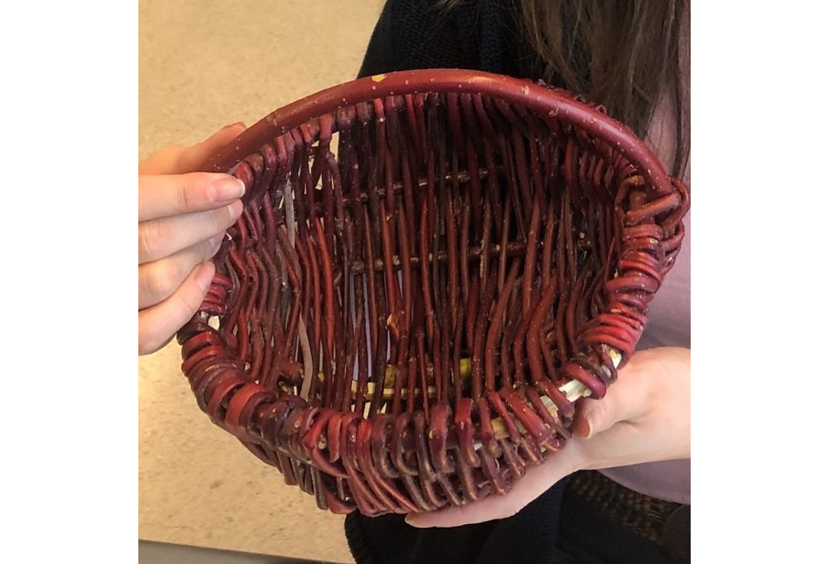 A person hodling a Red Willow Basket